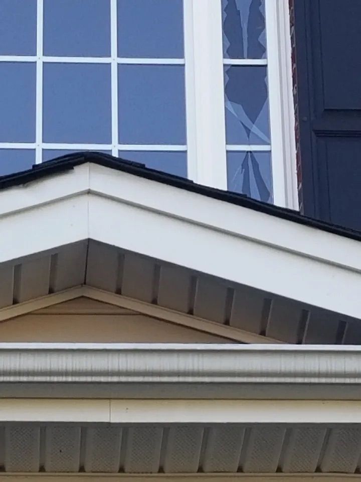 The roof of a house with a window and shutters