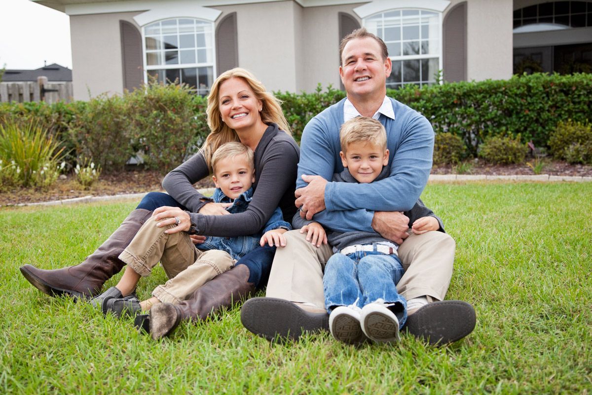 Family sitting in front of house — Redding, CA — Steven A. Small Attorney at Law