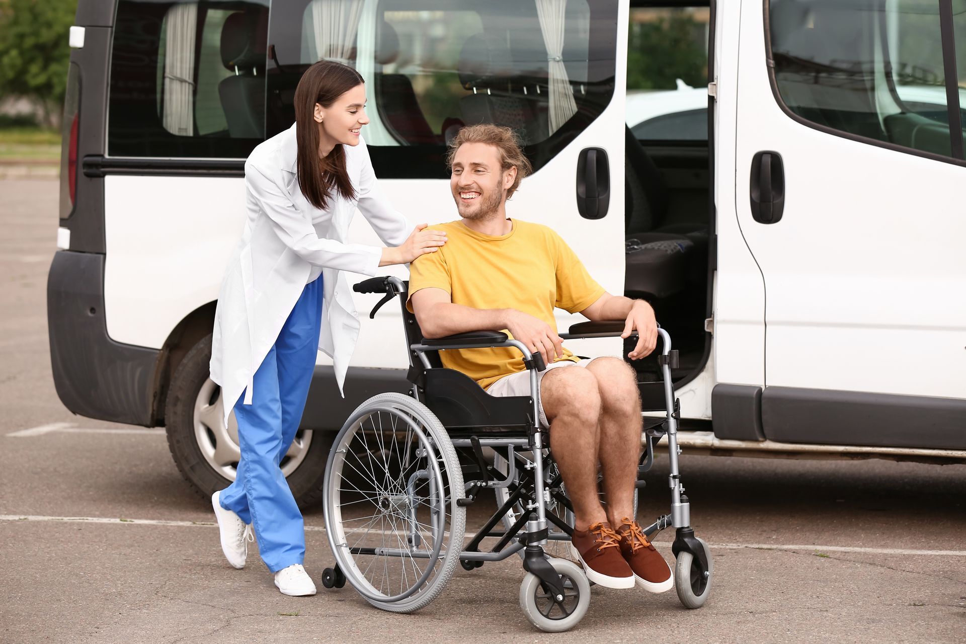 A doctor is greeting a man on a wheelchair.