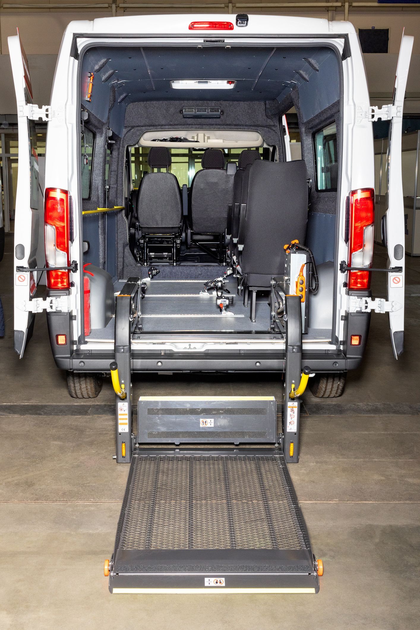 Modern van equipped with a wheelchair lift, as part of NEMT insurance plans.
