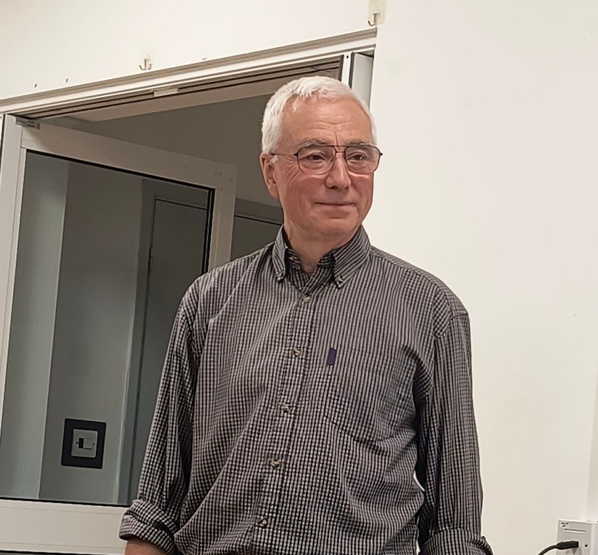 Photo of Alan Horgan standing at the front of the memorial hall