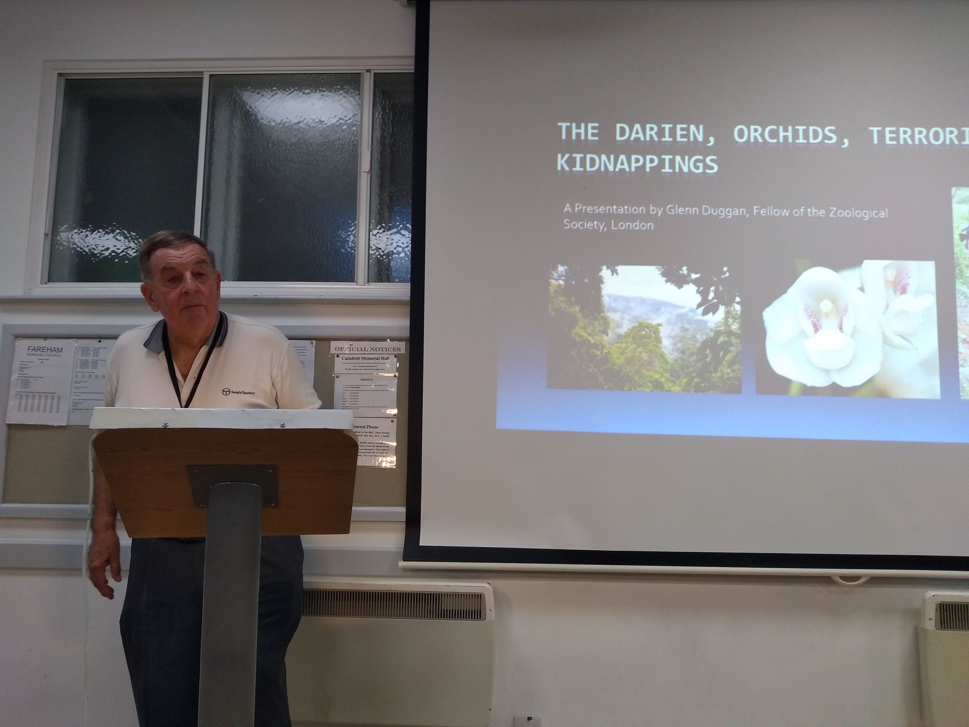 Photo of Glenn Duggan next to one of the slides he showed at the meeting Photo of Glenn Duggan next to one of the slides he showed at the meeting