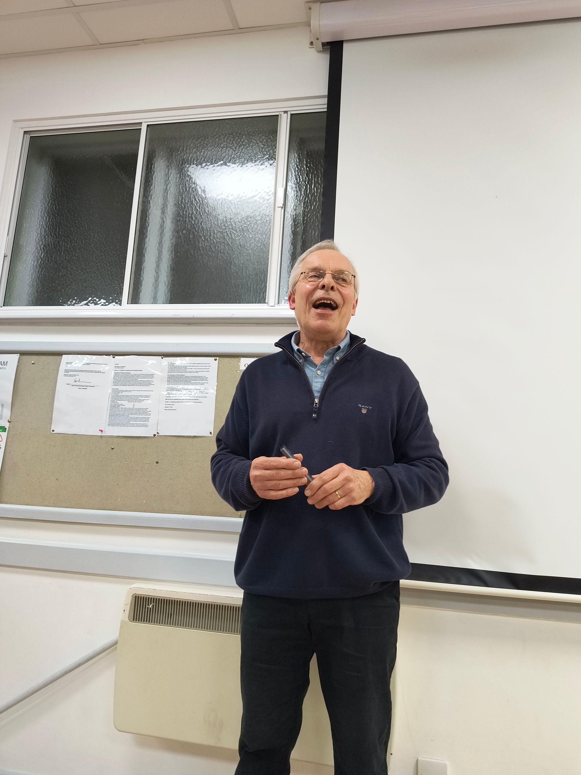 speaker Mark Porter enjoys a joke with Club members