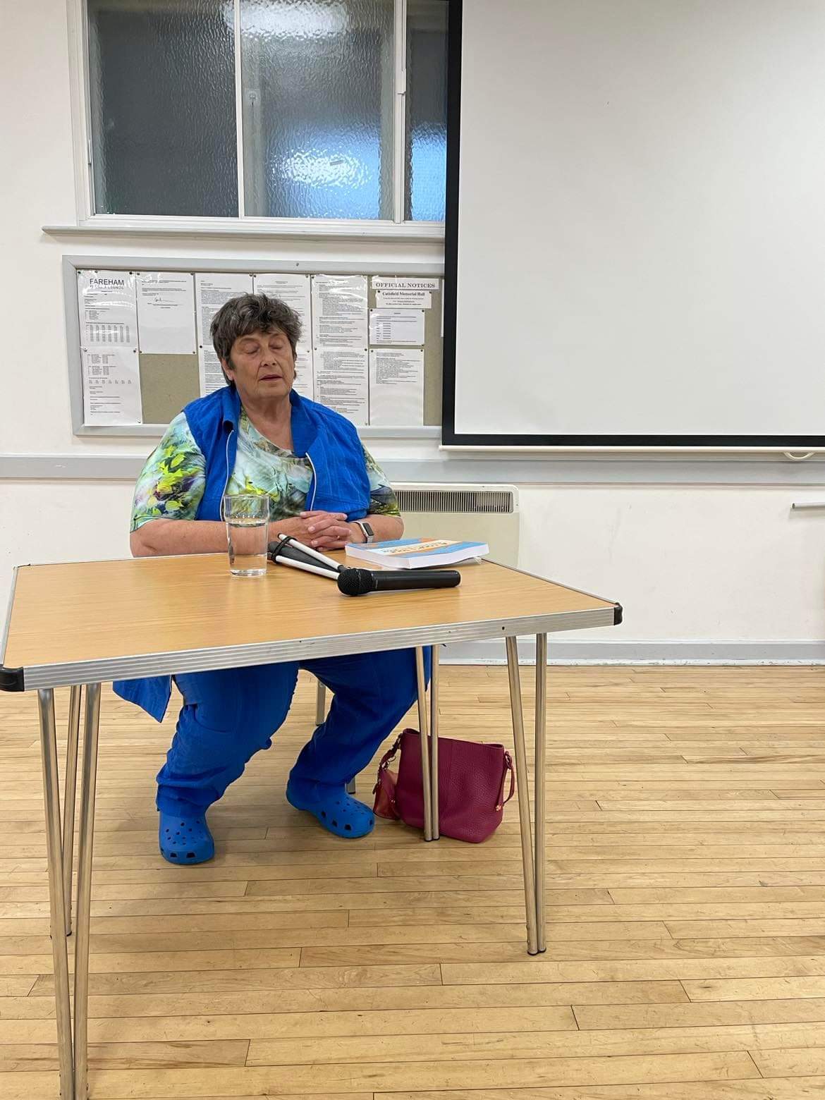 Photo of Penny sitting behind a table during her presentation
