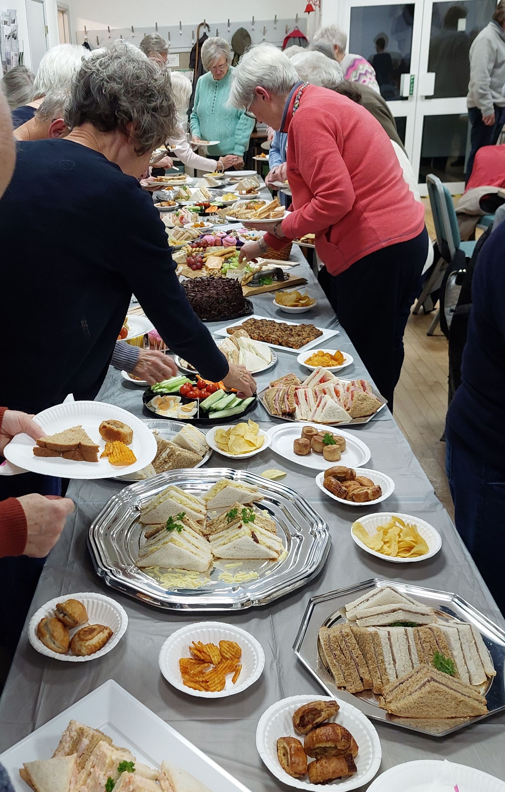 Picture of members helping themselves from the buffet