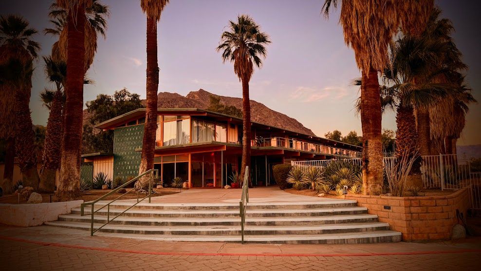 A large building with palm trees in front of it