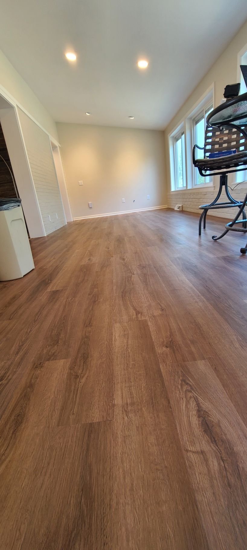 A living room with hardwood floors and a chair.