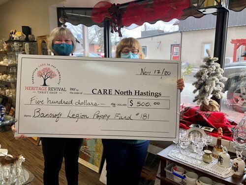 Two people in masks hold a $500 donation check for CARE North Hastings from the Bancroft Legion Poppy Fund.