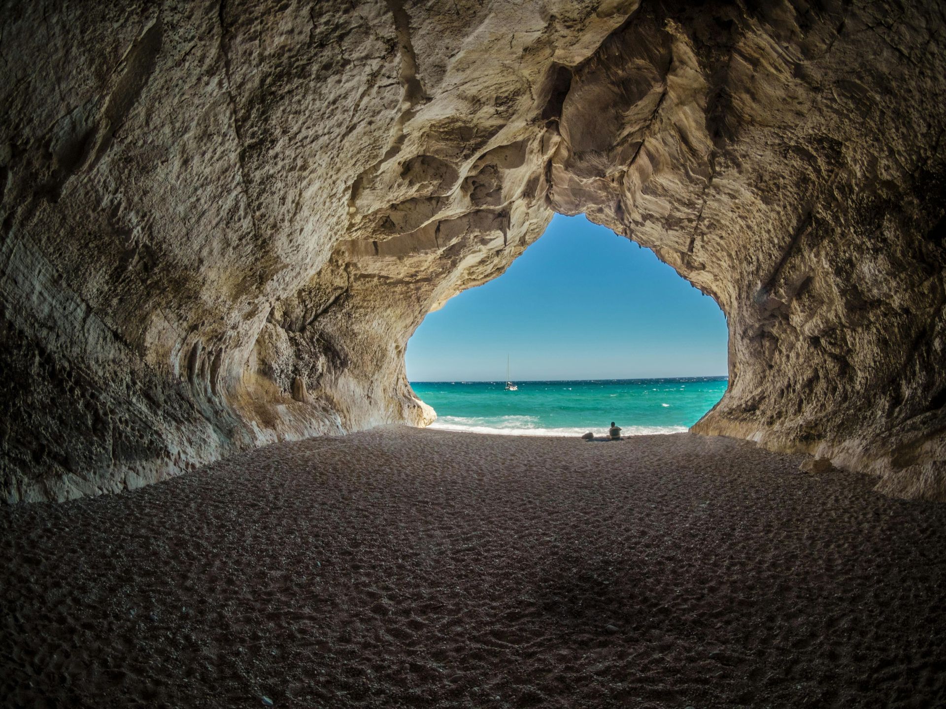 A view of the ocean from inside of a cave.