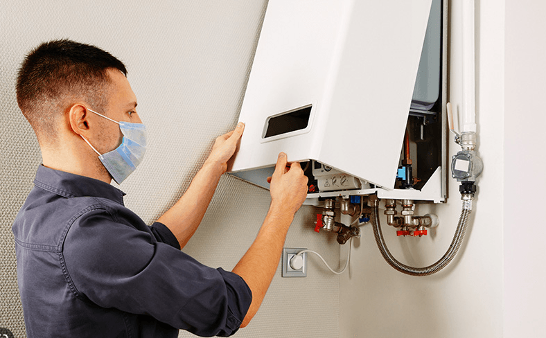 Man wearing a mask opening boiler 