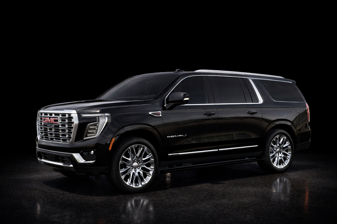 A black chevrolet suburban suv is parked on a white background.