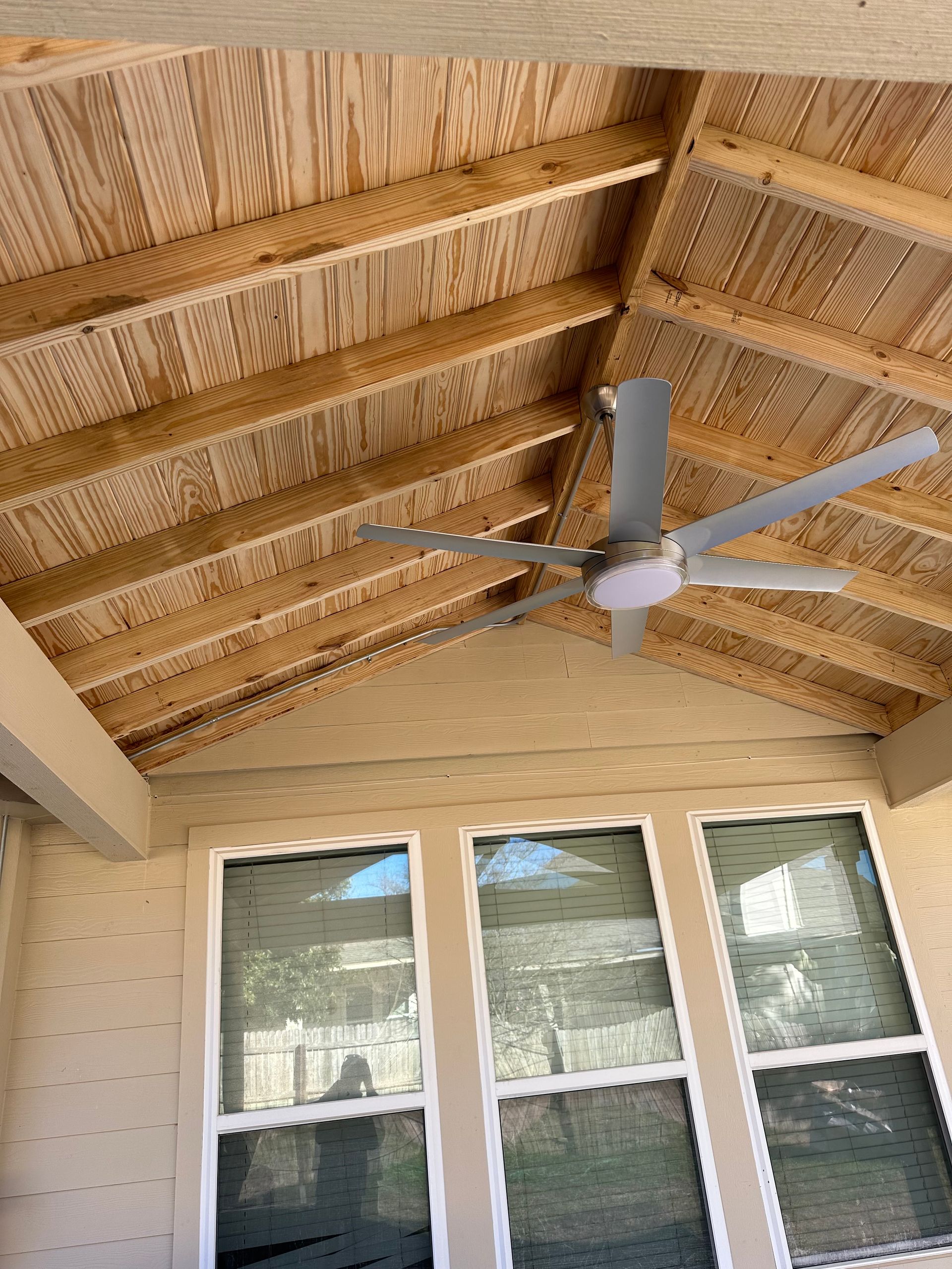 A ceiling fan is hanging from the ceiling of a house.