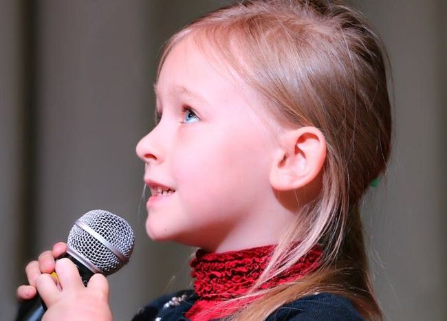 children and teens singing in a choir