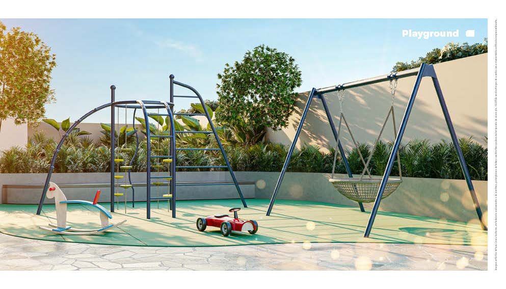 Parque infantil moderno com barras de escalada, balanços e um brinquedo vermelho em terreno arenoso ao lado de um muro e árvores.