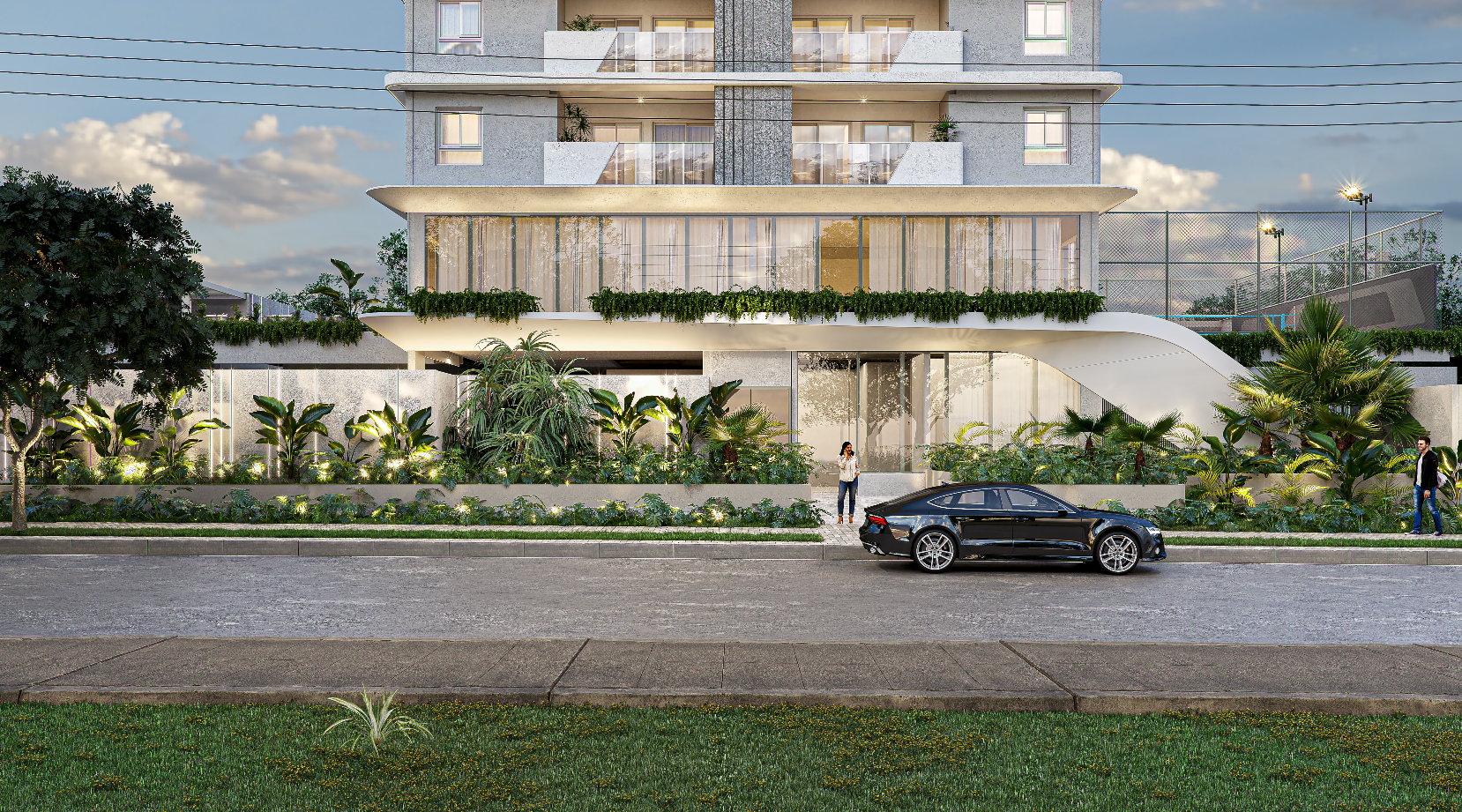 Prédio de apartamentos moderno com varandas iluminadas, um carro preto estacionado e vegetação ao longo da rua ao entardecer.