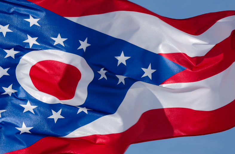 Ohio state flag with red, white, and blue design; a large red circle with a white O, and a blue field with white stars.