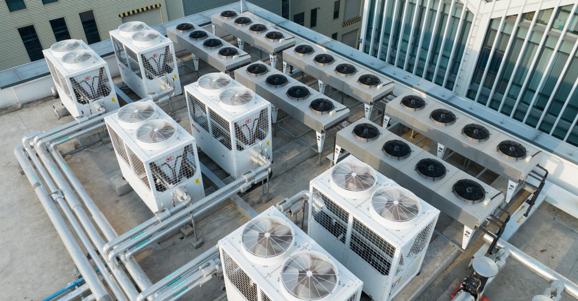 Brown rooftop HVAC units on a white roof, with one unit in the foreground and another behind it.