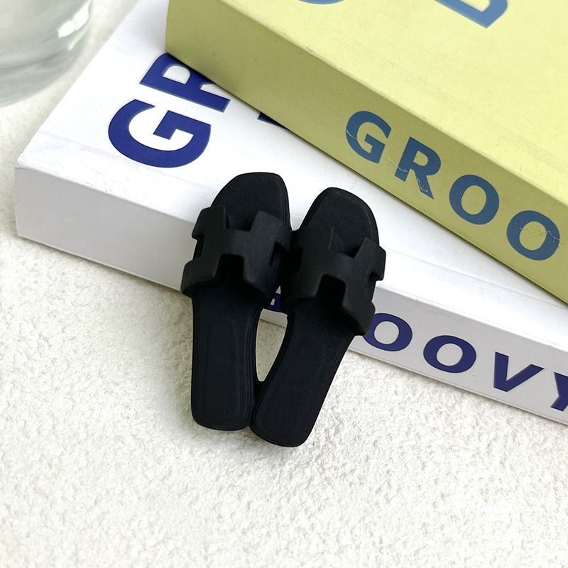A pair of black sandals sitting on top of a book titled groovy