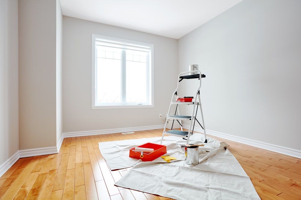 Empty Room With A Ladder And Paint Supplies On The Floor — Shane's Painting & Timber Restorations In East Toowoomba, QLD