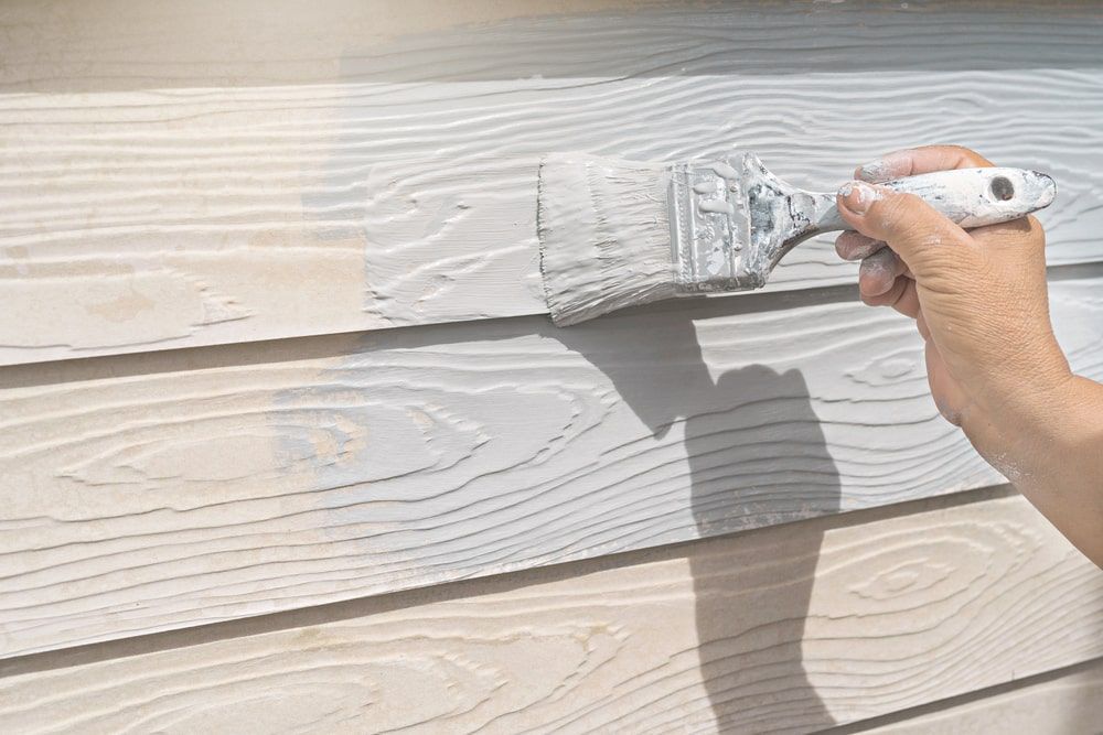 A Person Painting A Wooden Wall With A Brush — Shane's Painting & Timber Restorations In East Toowoomba, QLD