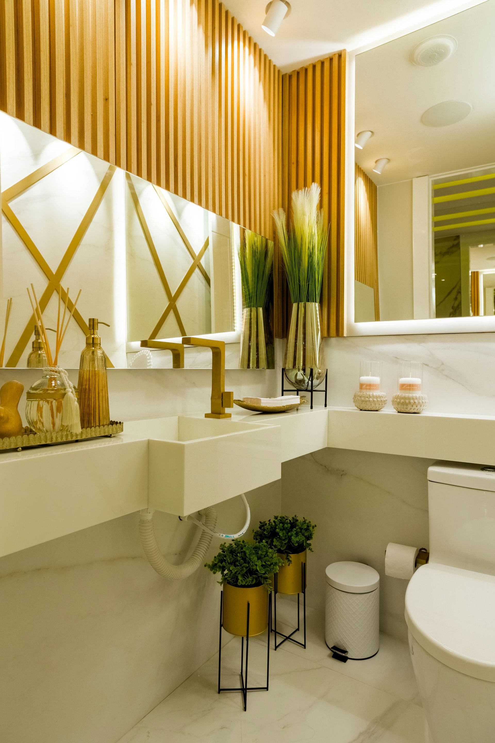 Contemporary bathroom remodel with floating vanity, gold hardware, and designer accent wall
