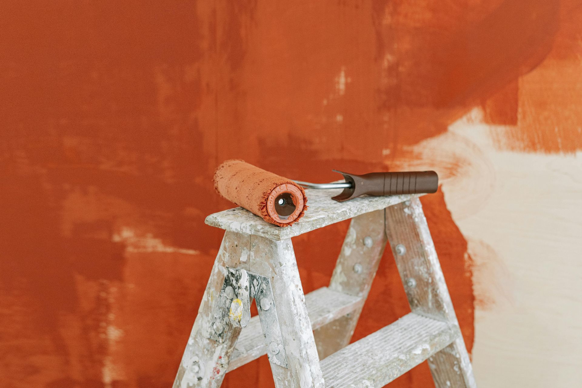 Home remodeling project showing paint roller and ladder for interior renovation