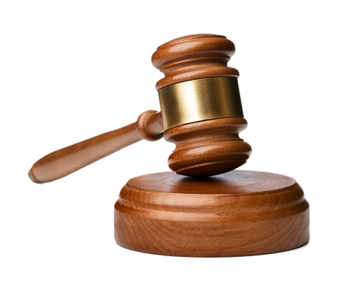 Gavel with golden band resting on  a sound block