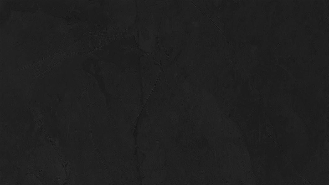 Dark, nearly black textured surface with faint vertical cracks and subtle scratches.