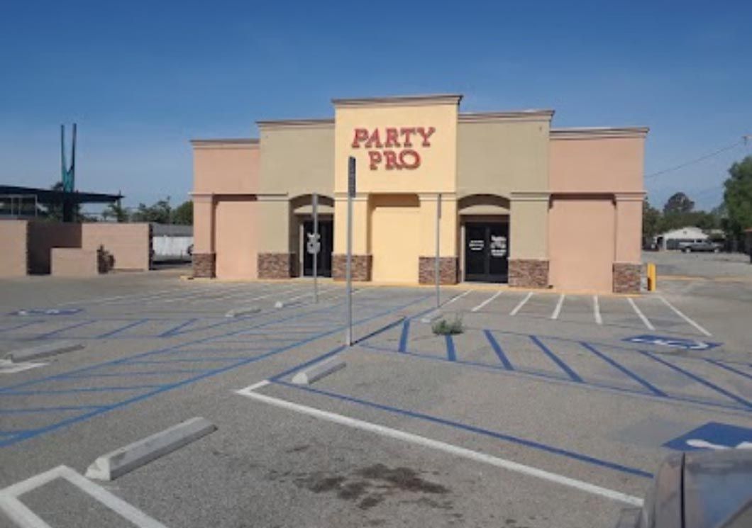 Party Pro storefront with empty parking lot and blue handicap lines
