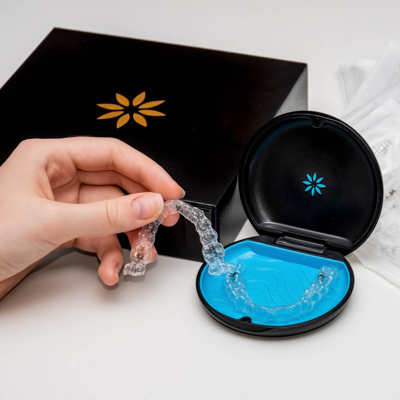 A person is holding a clear brace in front of a box