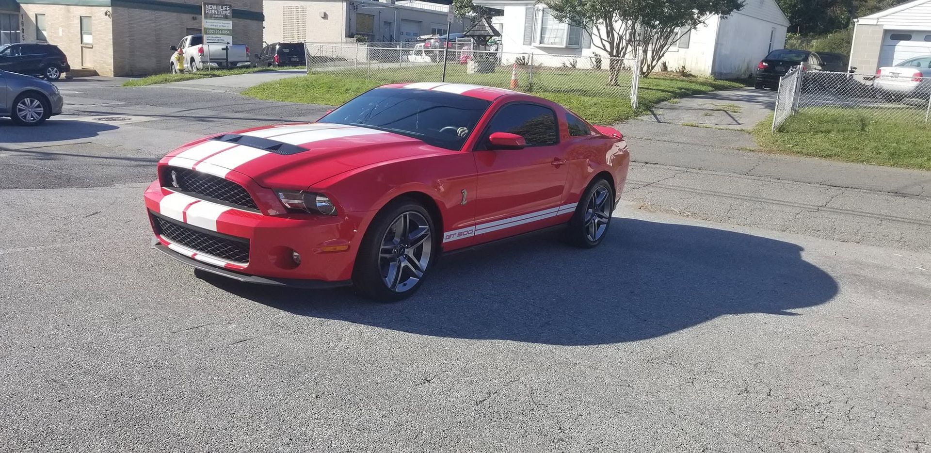 Window tinting on a red sports car with white racing stripes – Newport DE