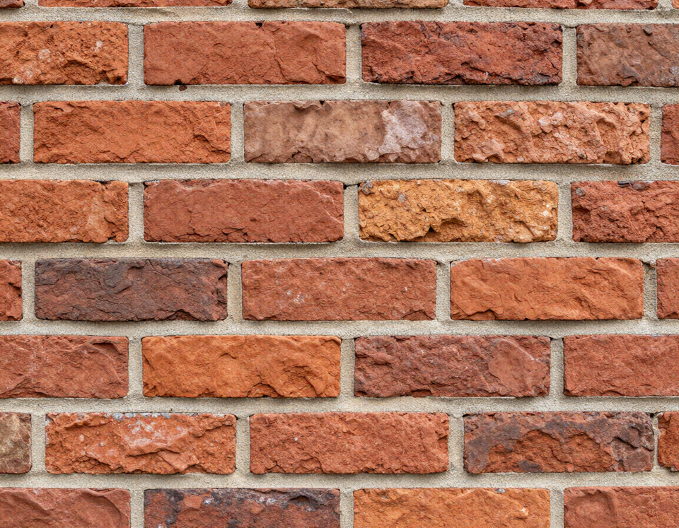 Freshly laid brick coursework showing mortar joints and color variation