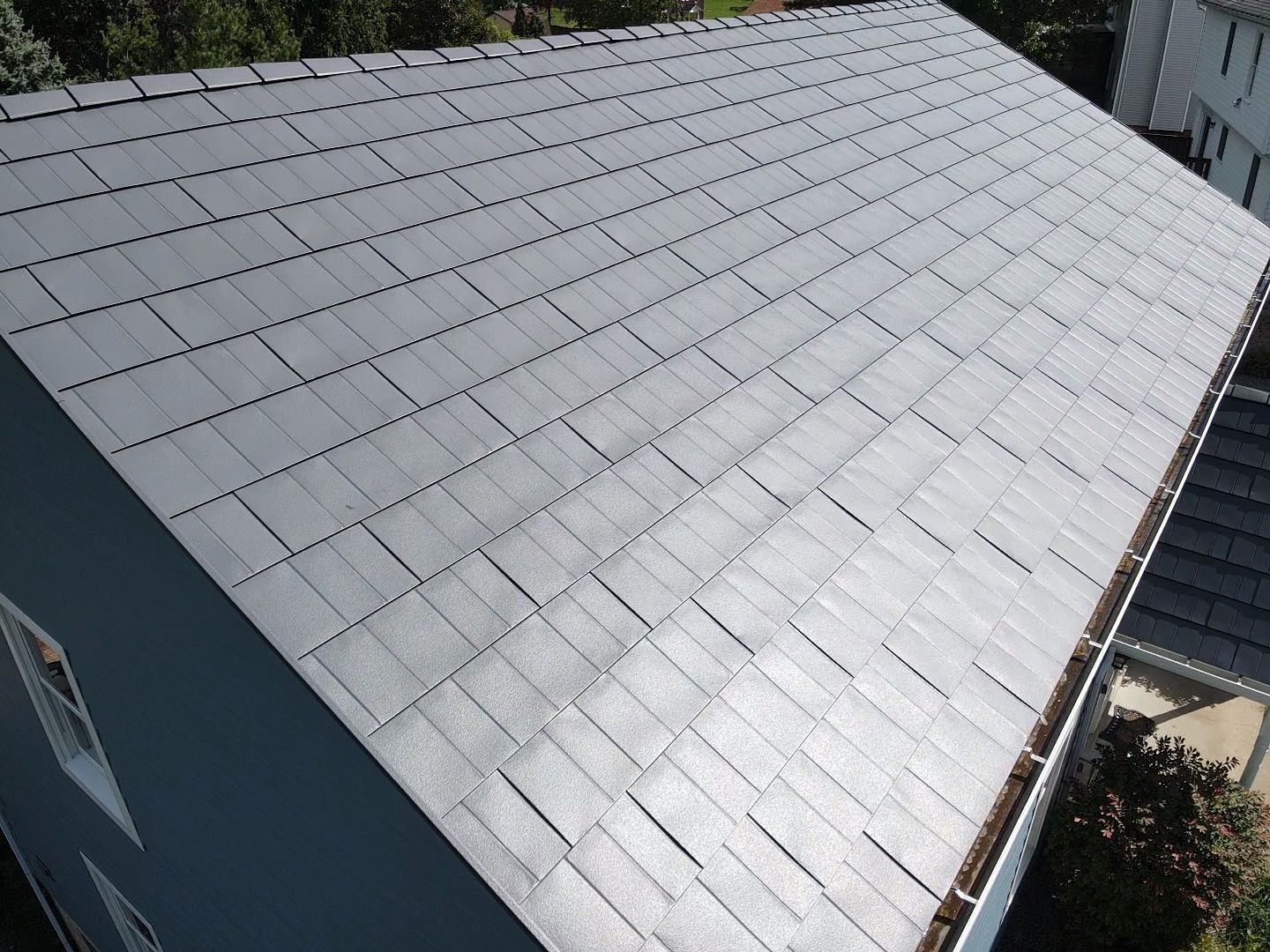 Gray shingled roof on a building, viewed from above at an angle