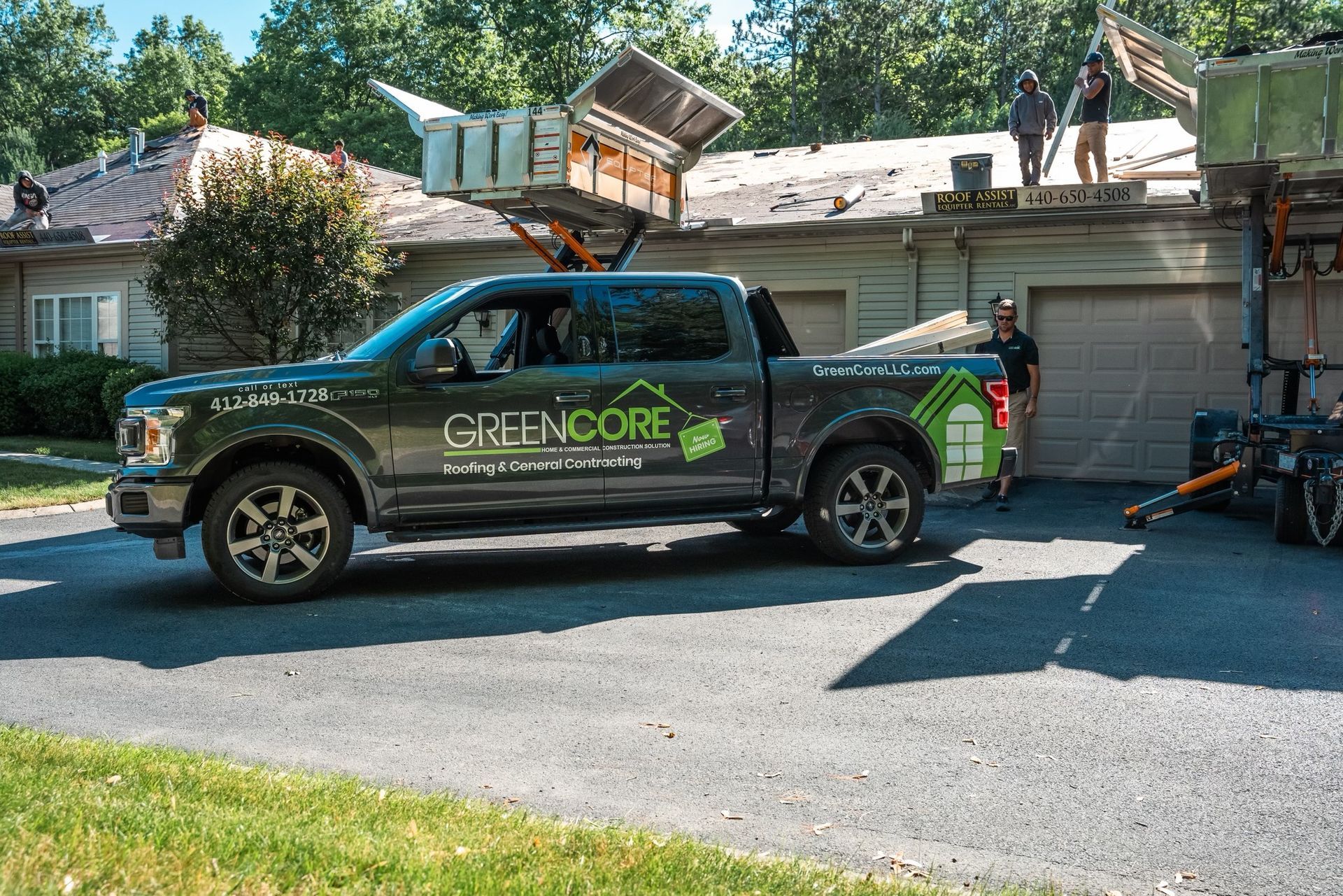GreenCORE service truck parked in a driveway with equipment in the back