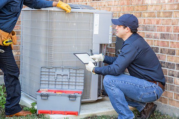 Air Conditioner Repairmen at Work — Killeen, TX — Artie's Heating AC Air Conditioner Repairmen at Work — Killeen, TX — Artie's Heating AC