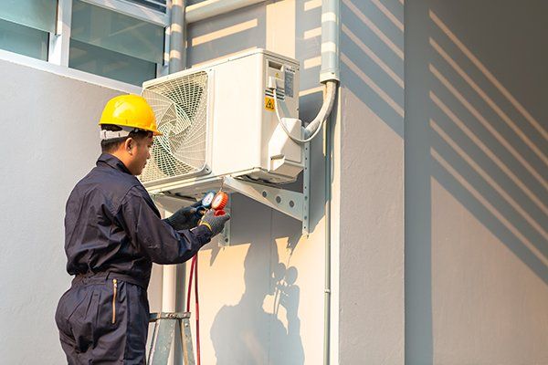 Technician Checking New Air Conditioner — Killeen, TX — Artie's Heating AC Technician Checking New Air Conditioner — Killeen, TX — Artie's Heating AC