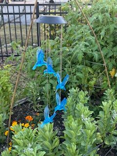 A garden with a wind chime in the middle of it.