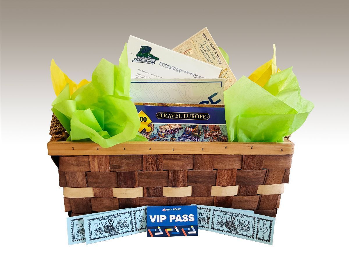 Gift basket with board game, VIP pass, and paper money.