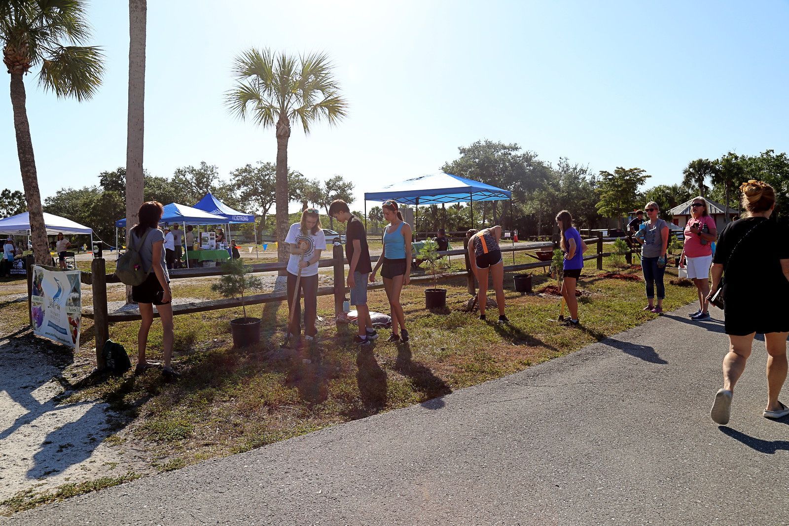 A group of people are standing in a grassy area