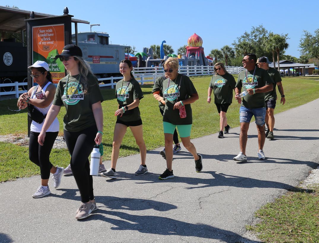 A group of people are walking down a path.