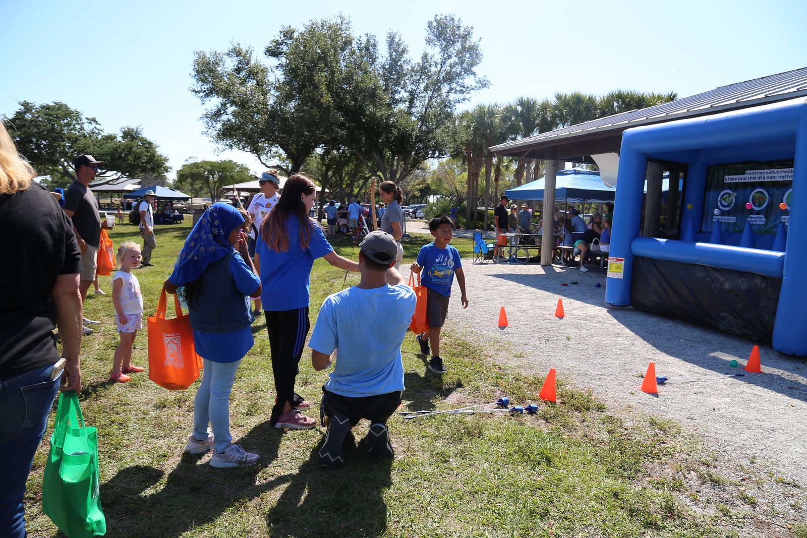 A group of people are playing a game in a park.