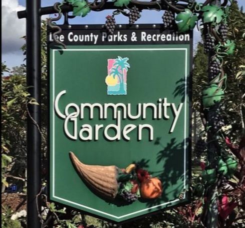 Sign for Lee County Community Garden with vines and cornucopia.