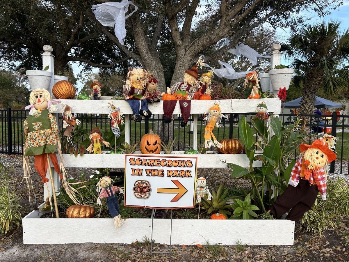 Halloween display: Scarecrows, pumpkins, sign