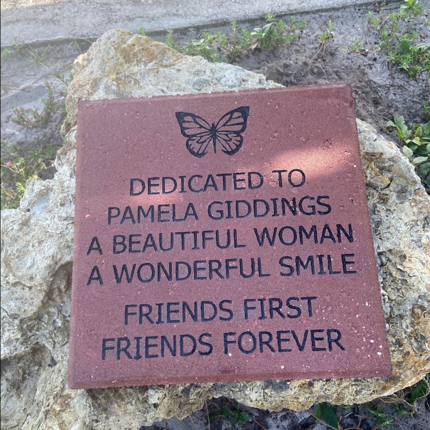 A plaque that says dedicated to pamela giddles a beautiful woman a wonderful smile friends first friends forever