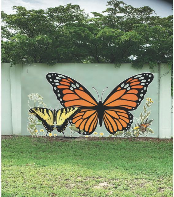 Two butterflies are painted on a white wall