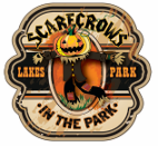 A scarecrow with a pumpkin head is on a sign that says scarecrows in the park.