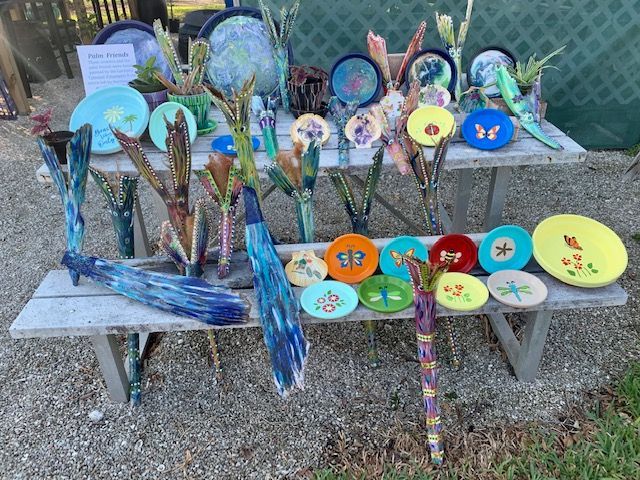 A table with a bunch of plates and vases on it