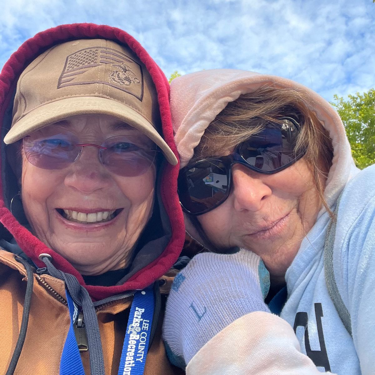 Two women are posing for a picture and one has a lanyard that says u.s. army