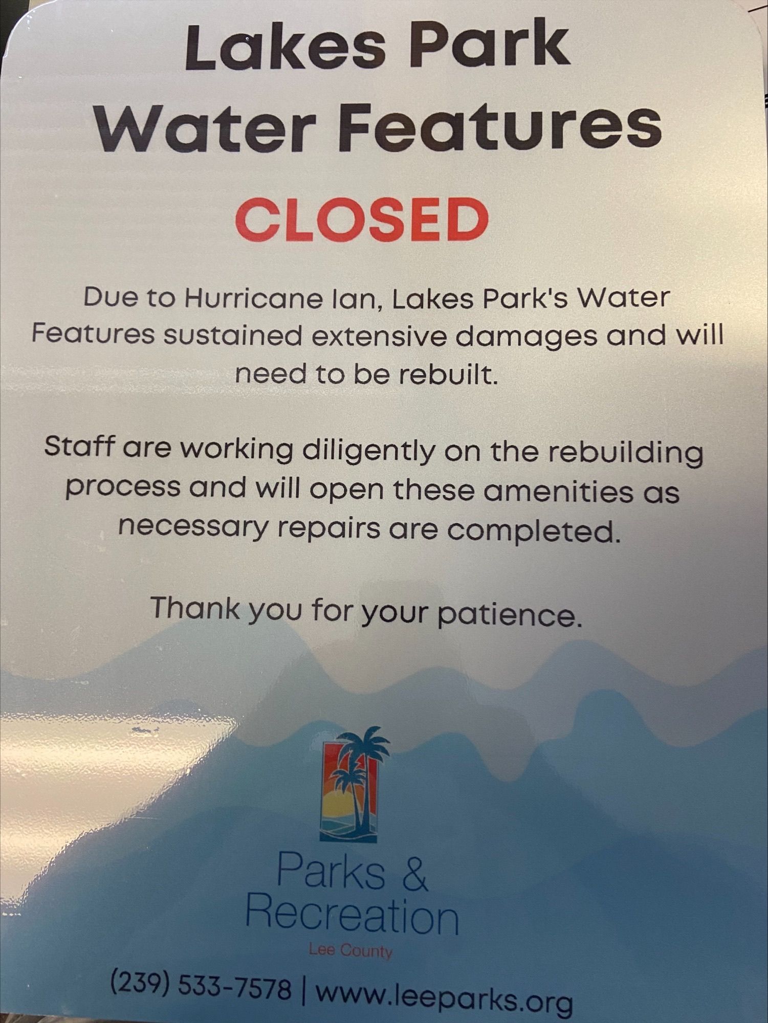 A sign that says lakes park water features closed
