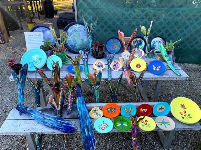 A table with a bunch of plates and vases on it